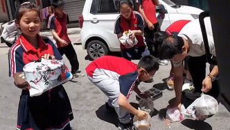 外賣小哥送餐時摔倒，一群小學生沖過來幫扶車