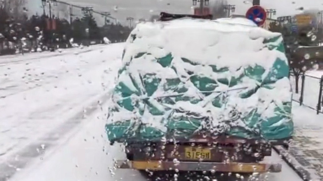 高速因大雪暂时封闭，交警为滞留司机送上开水、泡面等