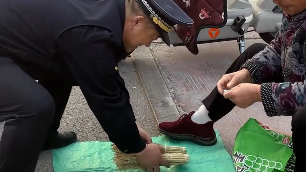 老人校門口擺攤遇城管，目擊者：城管掏錢幫“開張”，車流危險耐心勸離